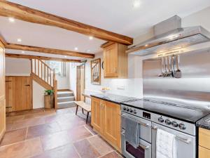 a kitchen with wooden cabinets and a stove at 3 Bed in Appleby-in-westmorland oc-94764 in Brampton