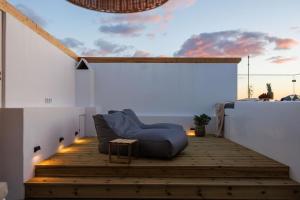 a living room with a blue couch on the stairs at Kalypso Vacation Home Naxos Town in Naxos Chora