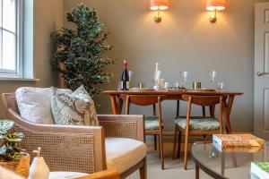 a dining room with a table with wine glasses on it at Old Orchard Elegance - Private Parking in Bath