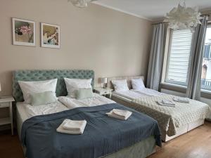 a bedroom with two beds with towels on them at Chopin's Apartment in Bielsko-Biała