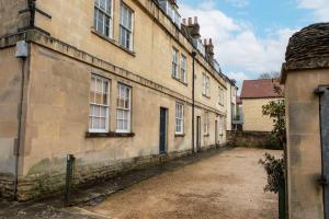 an alley in an old stone building with windows at Old Orchard Elegance - Private Parking in Bath