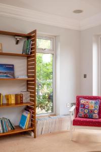 a living room with a red chair and a window at 5 Bed in Walberswick oc-troy in Walberswick