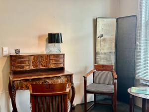 a room with a wooden desk and two chairs at V06 Seasidevilla Vlissingen in Vlissingen