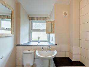 a bathroom with a sink and a toilet and a window at 2 Bed in Keswick oc-90064 in Threlkeld +13 photos