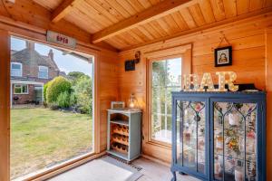 a room with a large window and a wine cellar at 3 Bed in Wrentham oc-15mill in Wrentham