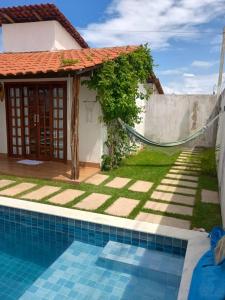 a villa with a swimming pool and a house at Chalé Brisa da Mata Baia Formosa in Baía Formosa