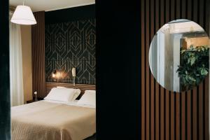 a bedroom with a bed and a mirror at Hotel Marconi in Fiuggi +84 photos