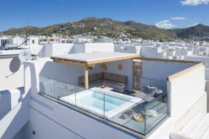 a glass house with a view of santorini at Kalypso Vacation Home Naxos Town in Naxos Chora