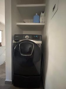 a washing machine in a corner of a room at Xcalacoco Beach in Playa del Carmen