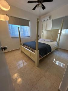 a bedroom with a bed and a ceiling fan at Xcalacoco Beach in Playa del Carmen