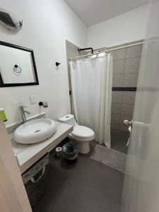 a bathroom with a toilet and a sink and a shower at Xcalacoco Beach in Playa del Carmen +25 photos
