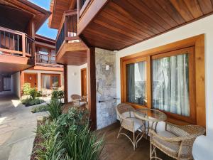 a patio with chairs and a table on a house at Blu Smart Stay in Búzios +19 photos