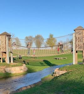a playground with people on a bridge over a river at Ferienwohnung Sonnenschein mit Sauna und Billiard in Wachstein