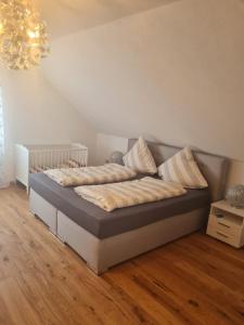 a bed with pillows on it in a room at Ferienwohnung Sonnenschein mit Sauna und Billiard in Wachstein