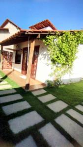 a small house with a grass yard in front of it at Chalé Brisa da Mata Baia Formosa in Baía Formosa