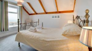 a bedroom with a bed with two towels on it at 3 Bed in Craster oc-79891 in Craster