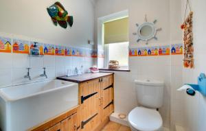 a bathroom with a sink toilet and a mirror at 3 Bed in Craster oc-79891 in Craster +9 photos