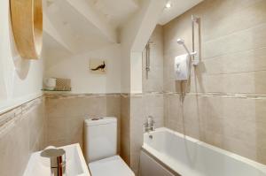 a bathroom with a toilet and a bath tub at 2 Bed in Kettlewell oc-ds985 in Kettlewell