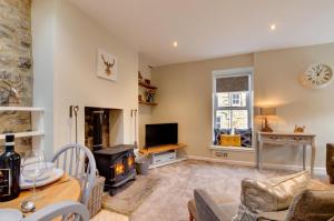 a living room with a fireplace and a tv at 2 Bed in Kettlewell oc-ds985 in Kettlewell