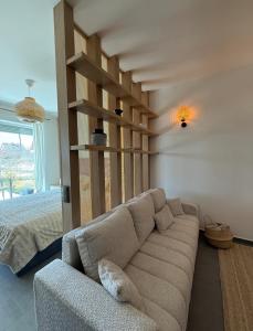a living room with a couch and a bed at The Balaton Nest! in Alsóörs