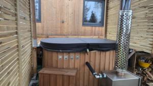 a sauna in a wooden cabin with a stove at Tiny House chez Lili in Frémifontaine