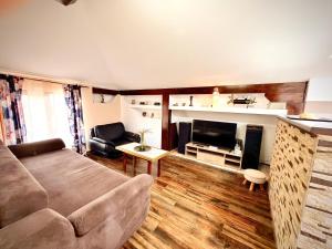 a living room with a couch and a fireplace at La Mansardă in Câmpulung
