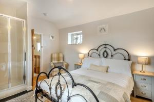 a bedroom with a large bed and a glass door at 2 Bed in Grimston oc-1622 in Grimston