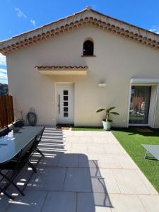 a patio in front of a white house at l’Anita in Théoule-sur-Mer
