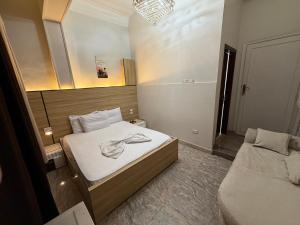 a small bedroom with two beds and a mirror at Abdeen Cairo Hostel in Cairo