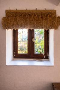 a window in a room with a window sill with a curtain at La casina de Barro in Llanes