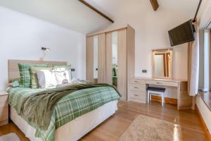 a bedroom with a bed with a mirror and a television at 1 Bed in Wonastow oc-l29426 in Wonastow