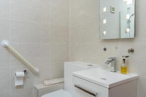 a bathroom with a toilet and a sink and a mirror at 1 Bed in Wonastow oc-l29426 in Wonastow +11 photos