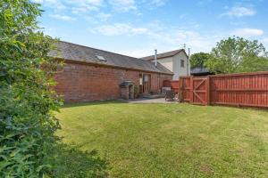 a yard with a brick building and a fence at 1 Bed in Wonastow oc-l29426 in Wonastow