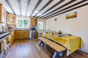 a kitchen with a table with a yellow table cloth at 5 Bed in Clows Top oc-m32976 in Bayton