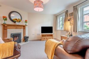 a living room with a couch and a television at 2 Bed in Weobley oc-c32945 in Weobley