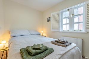 a bedroom with a bed with two towels on it at 2 Bed in Weobley oc-c32945 in Weobley