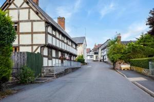 an empty street in a town with white buildings at 2 Bed in Weobley oc-c32945 in Weobley
