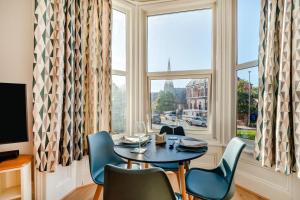 a dining room with a table and chairs and a window at 1 Bed in Bridlington oc-t30002 in Bridlington