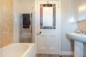a bathroom with a bath tub and a sink at 1 Bed in Bridlington oc-t30002 in Bridlington +13 photos