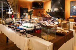 a buffet table with bread and pastries on it at Palais Mirage d'Atlas, Hôtel & Spa in Marrakesh