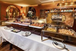 a buffet with several trays of food on display at Palais Mirage d'Atlas, Hôtel & Spa in Marrakesh