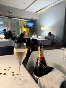 a bottle of wine and a glass on a table at Aqua Ria Boutique Hotel in Faro