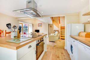 a kitchen with white cabinets and a refrigerator at 3 Bed in Llanrwst oc-wag689 in Llanrwst