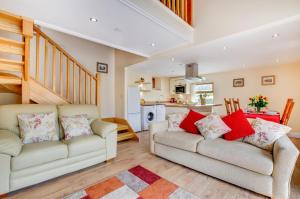a living room with two couches and a kitchen at 3 Bed in Llanrwst oc-wag689 in Llanrwst