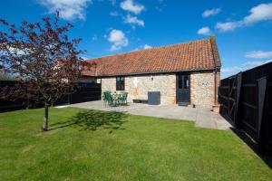 a brick house with a yard with a tree at 2 Bed in Roughton oc-1626 in Roughton