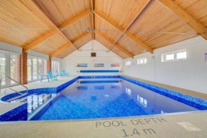 a large swimming pool with a wooden ceiling at 2 Bed in Roughton oc-1626 in Roughton