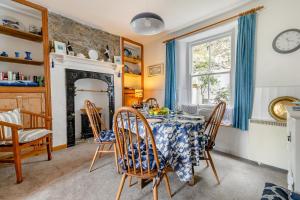 a dining room with a table and chairs and a fireplace at 3 Bed in Porthleven oc-7bayvi in Porthleven
