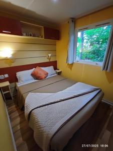 two beds in a small room with a window at Tiny Sweet Home - 3 nuits minimum in Saint-Chéron