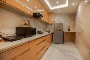 a kitchen with a refrigerator and a counter top at Samar Villa BnB in Shimla