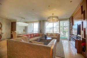 a living room with a couch and a tv at Samar Villa BnB in Shimla